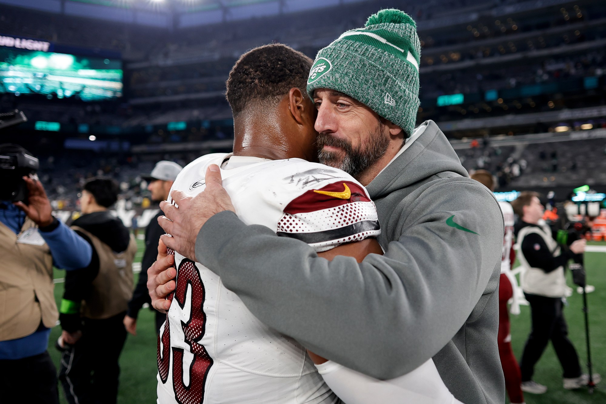 New York Jets quarterback Aaron Rodgers, right, hugs Washington Commanders defensive tackle Jonathan Allen (93) after an NFL football game, Sunday, Dec. 24, 2023, in East Rutherford, N.J. (AP Photo/Adam Hunger)